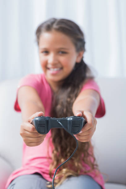 istock Happy girl playing video game on sofa 847076136