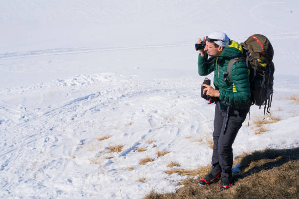 istock Man with backpack is taking a photo on Hardangervidda plane in Norway 847076702