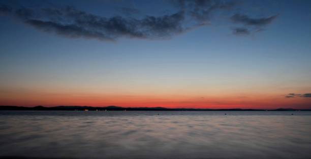 istock dark Cirrus clouds at sunset over the lake 847076772