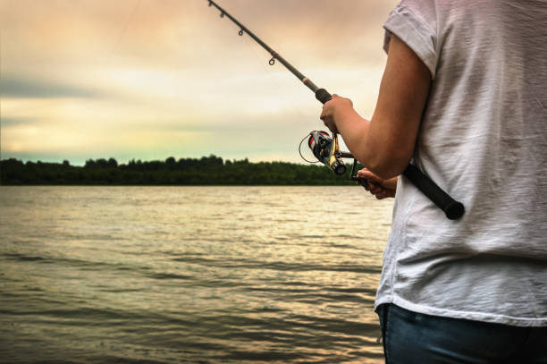istock hands holding a fishing rod and twist the handle 847076830