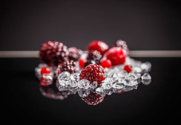 Frozen berries in a glass bowl, isolated on a white, horizontal