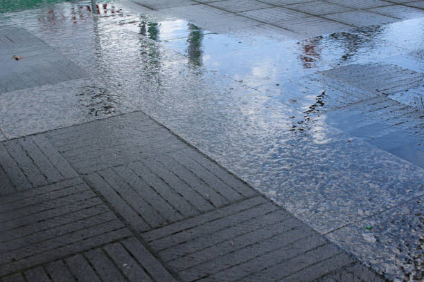 It is a blue sky reflected in the puddle of the sidewalk on the rain.