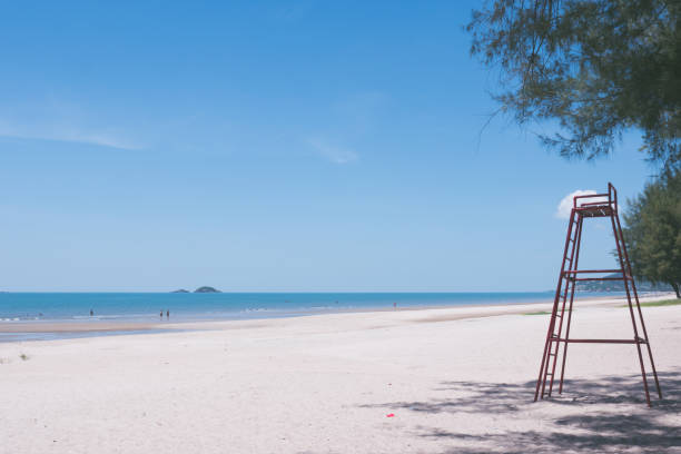 istock Beautiful beach with blue sky and a tall red lifeguard chair. 847084440