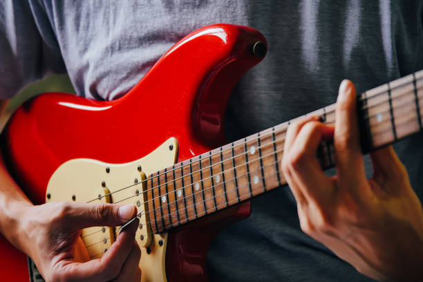 istock Close up of male hands playing electric guitar. Selective focus 847085508