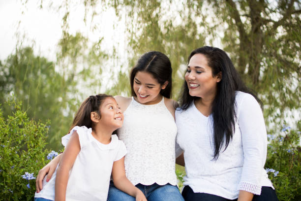 istock Latin mother with her two daughters smiling at each other 847088052