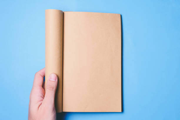 istock Top view of hands holding a blank book ready with copy space ready for text on blue background. 847088142