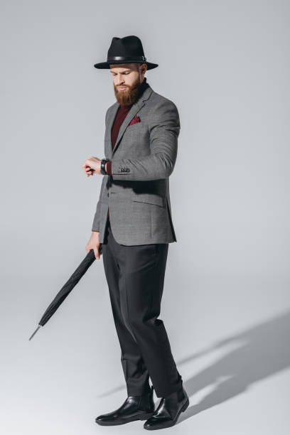 istock stylish man in hat with umbrella 847094136
