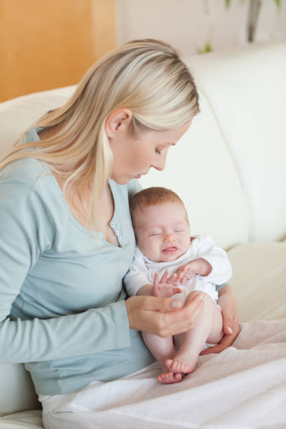 istock Mother on the sofa with her baby on her lap 847101134