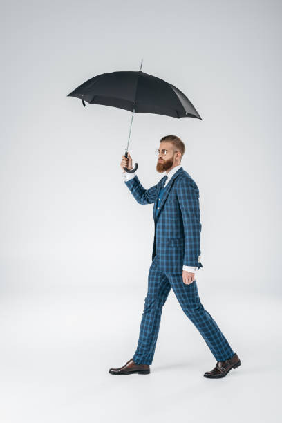 istock attractive young man with umbrella 847101230