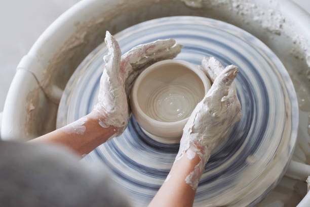 making clay jug Close-up image of woman working on clay pot pottery making stock pictures, royalty-free photos & images