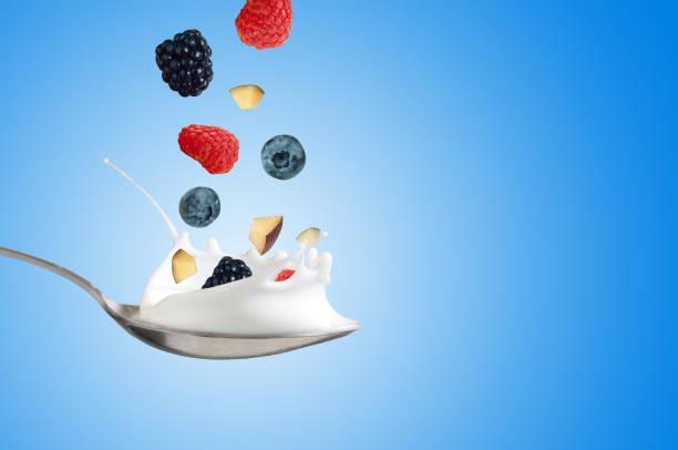 istock Fresh Raspberry, blueberries splashing into milk or yogurt 847104186