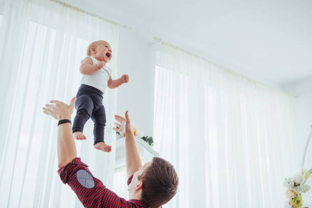 istock Father throwing hand high air joyful daughter. 847105454