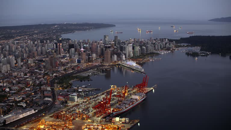 AERIAL View of Vancouver from above the Vancouver Harbour at dusk