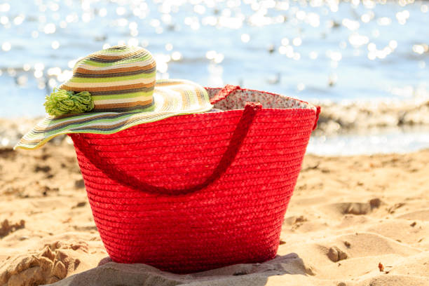 istock Wicker basket handbag bag and hat on summer beach. 847118908