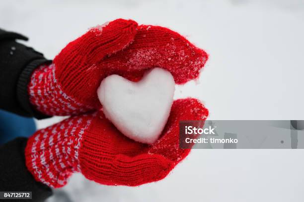 Red Female Gloves Hold A White Heart From The Snow Stock Photo - Download Image Now - Winter, Child, Snow