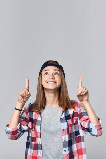 istock Teen girl pointing up at empty copy space 847134444