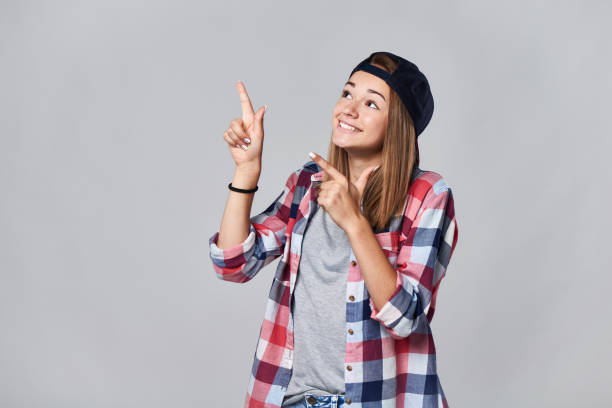 istock Teen girl pointing up at empty copy space 847134724