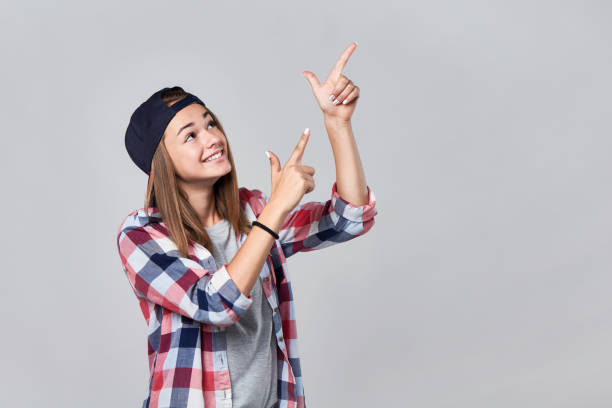 istock Teen girl pointing up at empty copy space 847136850