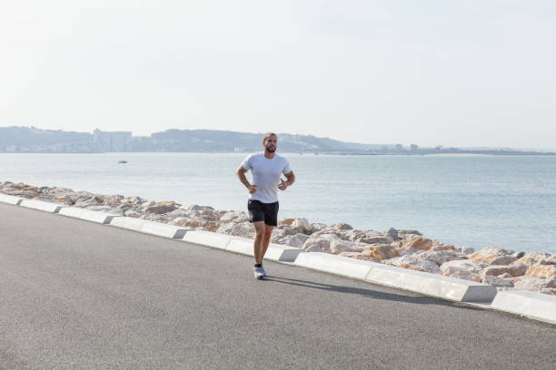 istock Serious Sporty Young Man Running on Seaside Road 847138008