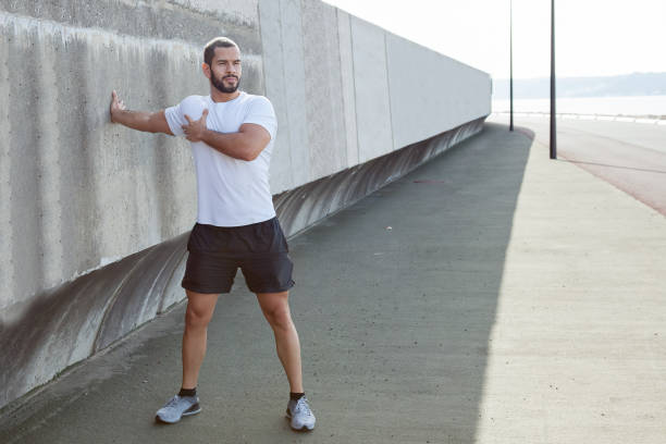 istock Strong Sporty Man Stretching Arm Outdoors 847138068