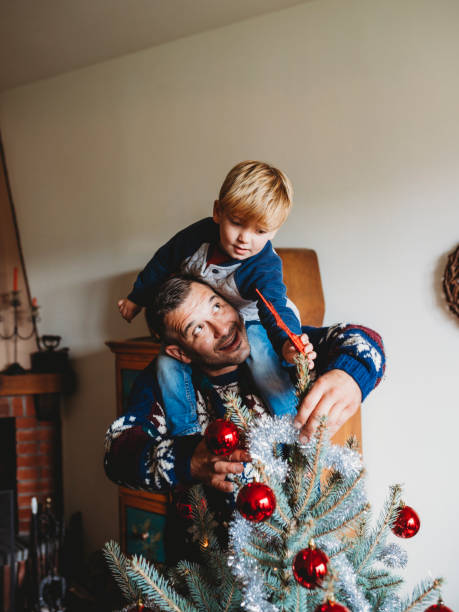 istock Happy family decorating Christmas tree together 847144506