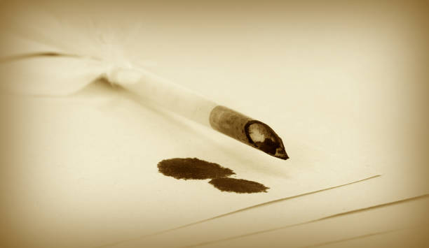 istock Quill pen with ink blots on papers 847145632