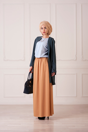 young beautiful Islamic woman in modern oriental clothes with handbag, Ufa