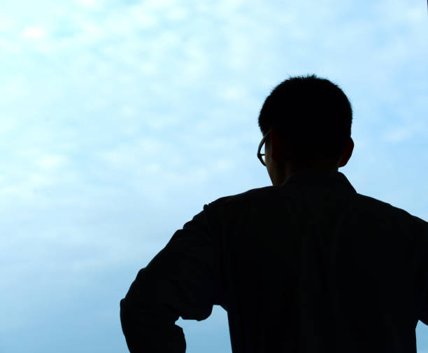 istock Silhouette Asian business man isolated on blue sky 847148814