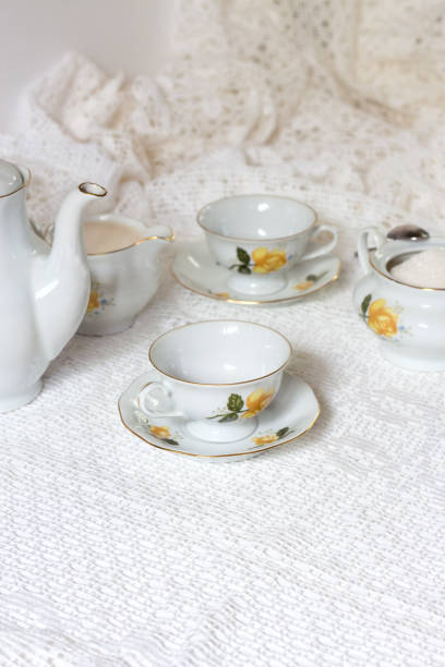 istock Coffee pot cup saucer cakes sugar on white background 847152764
