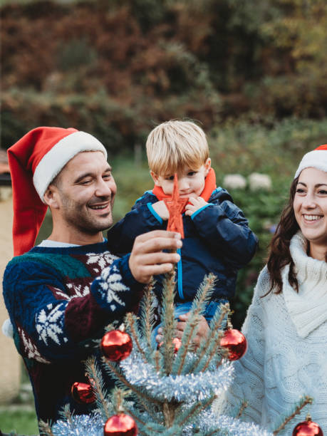istock Happy family decorating Christmas tree together 847153402