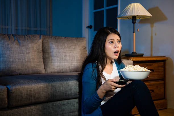 istock lovely young woman holding popcorn snack 847159472
