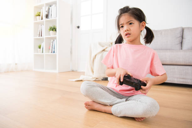istock girl holding game joystick watching video game 847160810