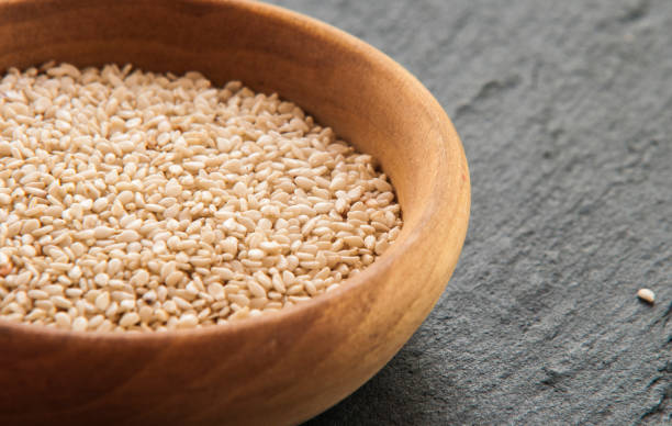istock Sesam seeds in a little bowl wooden Natural light. Selective focus. 847160874