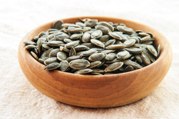 istock Full bowl of pumpkin seeds close up 847160888