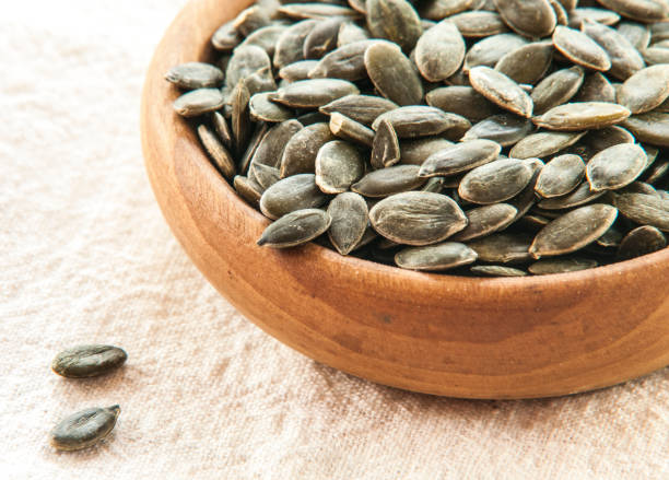 istock Full bowl of pumpkin seeds close up 847160964