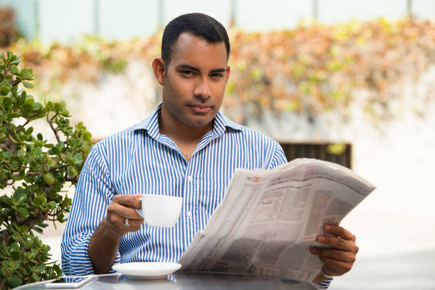 istock Handsome Hispanic Man with Coffee and Newspaper 847161346