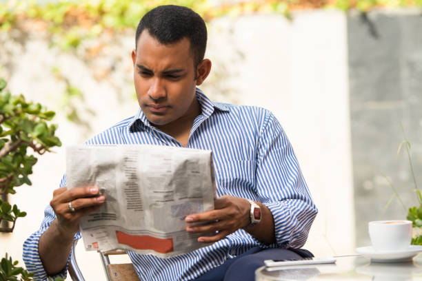 istock Serious Man Reading Newspaper in Outdoor Cafe 847161506