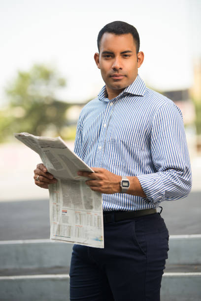 istock Portrait of Confident Hispanic Man with Newspaper 847161526