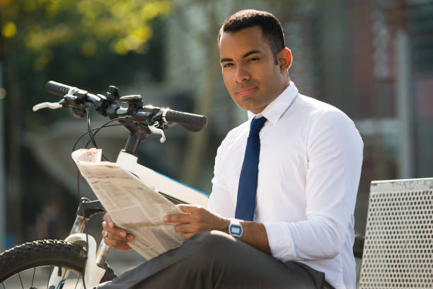 istock Smiling Latin Businessman with Newspaper in Park 847161722