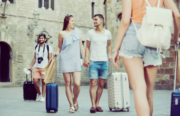 istock Smiling couple in shorts with luggage 847169544
