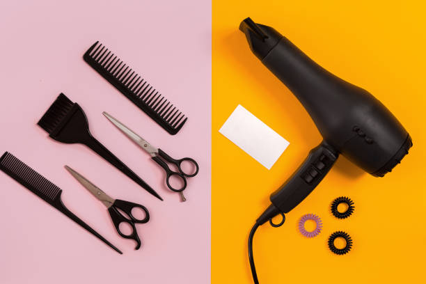 istock Hairdresser tools on pink and orange background with copy space 847171678