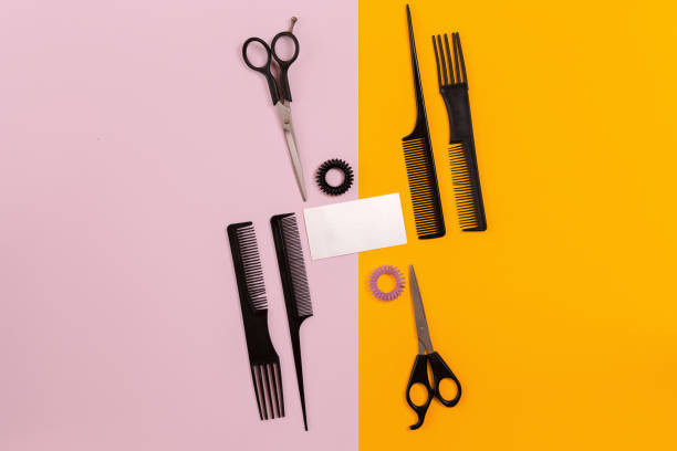 istock Hairdresser tools on pink and orange background with copy space 847171828
