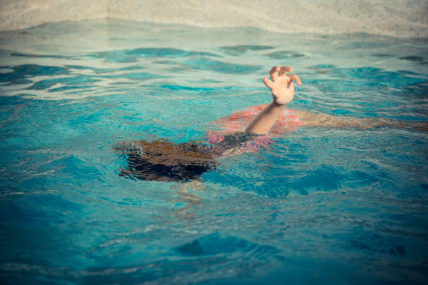 young little girl floating at swimming pool