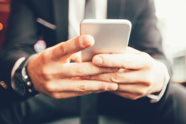 istock Close-up of male hands using smartphone in cafe 847172576