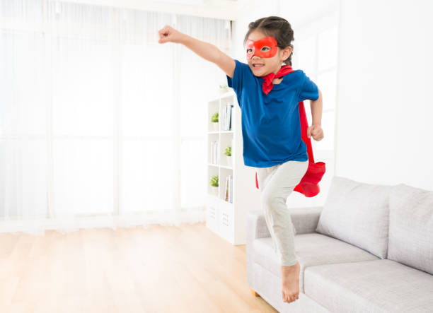 istock attractive sweet little girl jumping from sofa 847173092