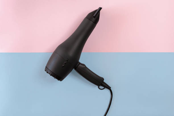 istock Black Hair dryer on blue and pink background 847173256