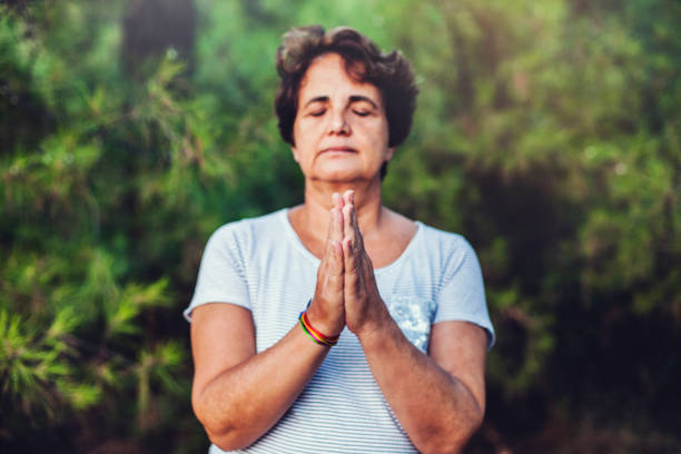 istock Mature woman meditating 847176668