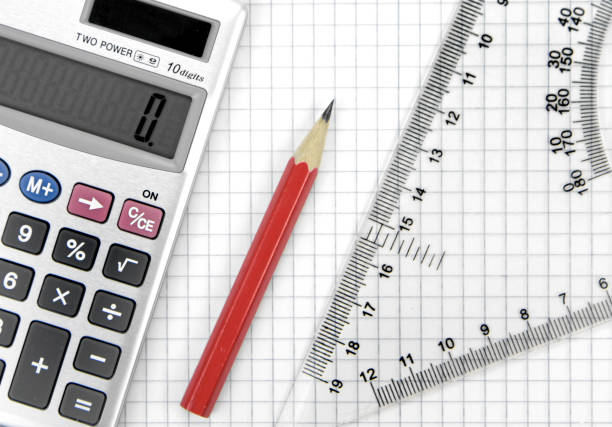 istock Calculator, lead pencil and ruler on squared paper 847176710