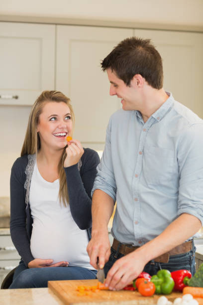 istock Man preparing vegetables for pregnant wife 847176832