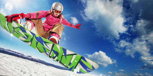 sports background. snowboarder jumping through air with deep blue sky in background. - skiing winter women snow imagens e fotografias de stock